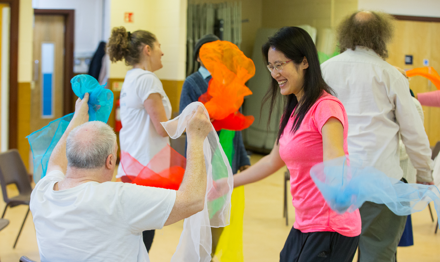 A varied ability dance class with colourful props