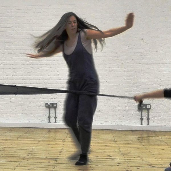 Three dancers in motion in studio